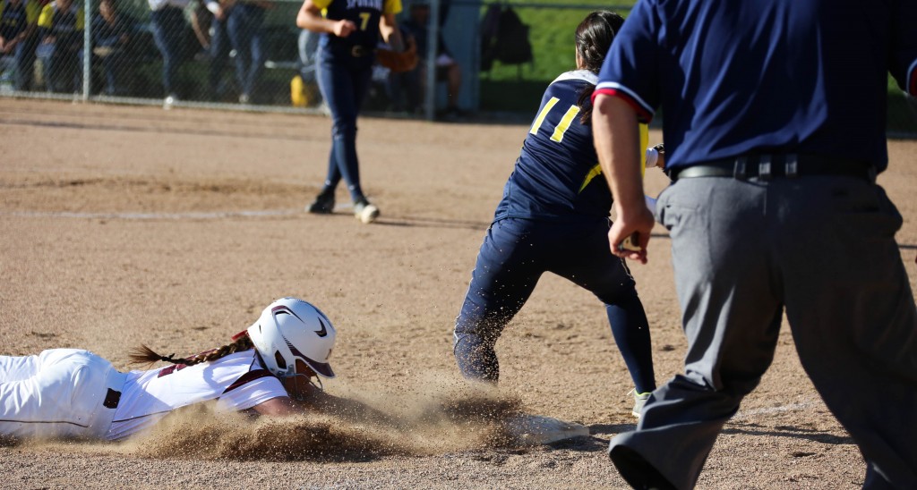 Freshman Analisa Rayner slides face-first safely into third base.  Katie Hartwig/Sentinel