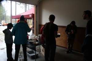 The volunteers of Adopt A Crag prep their burgers before enjoying them.