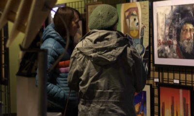 Two Women look at art display