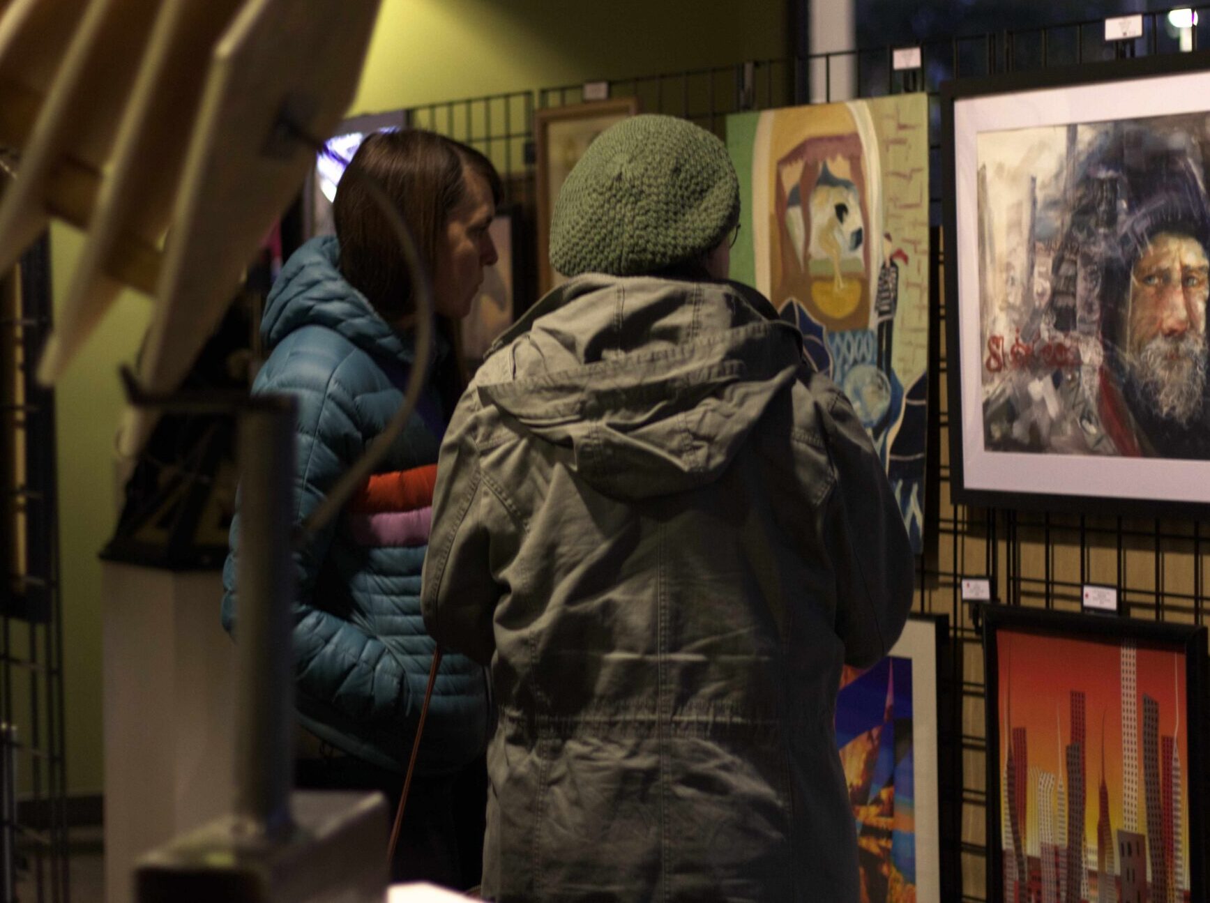 Two Women look at art display