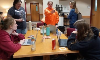 Students making buttons at FUNbrary event at the Molstead Library.
