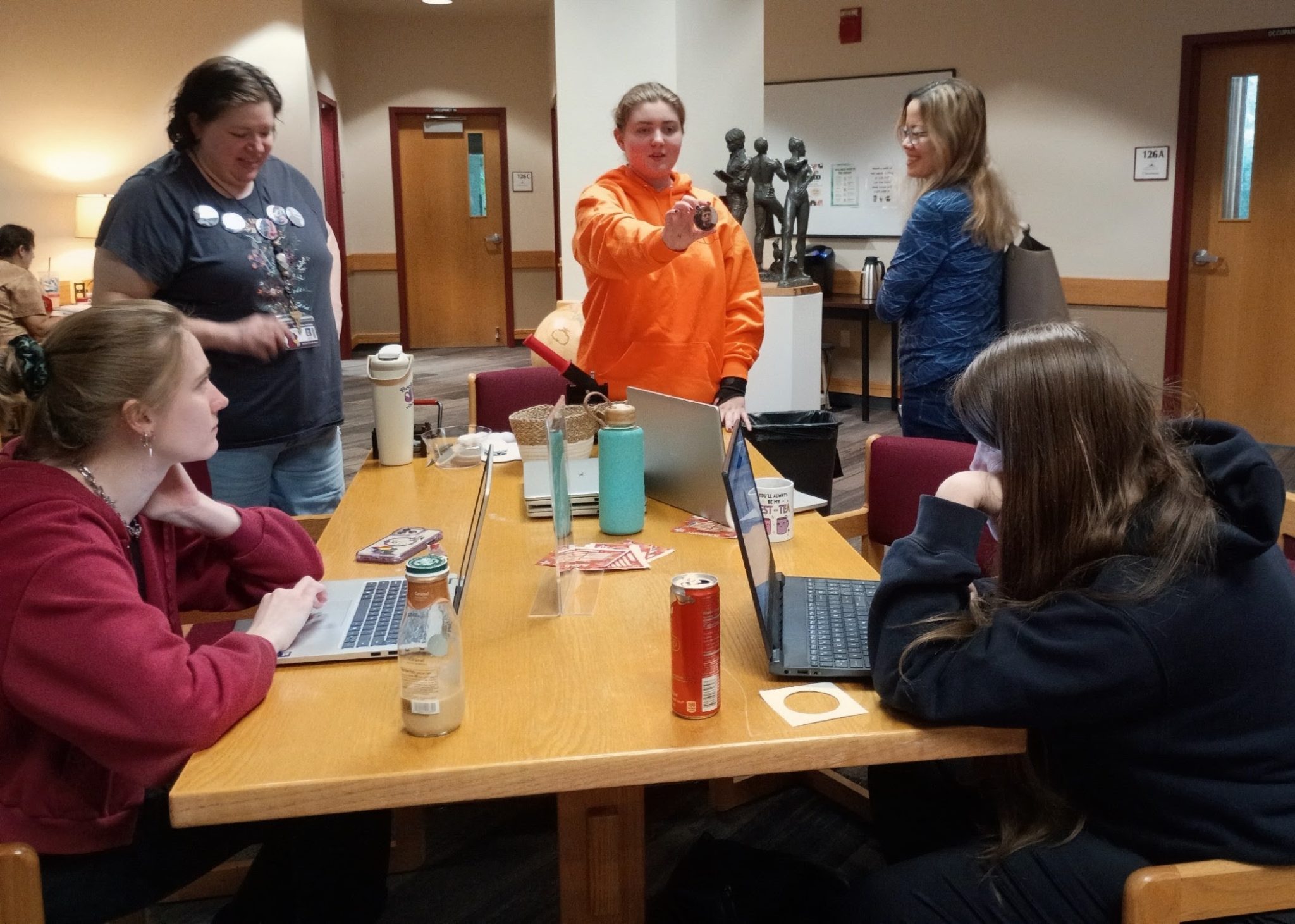 Students making buttons at FUNbrary event at the Molstead Library.